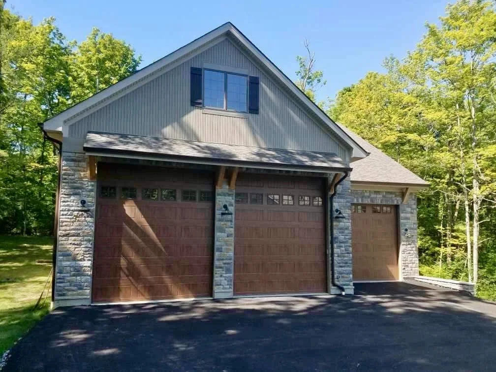 Three-bay detached garage beside a wooded property