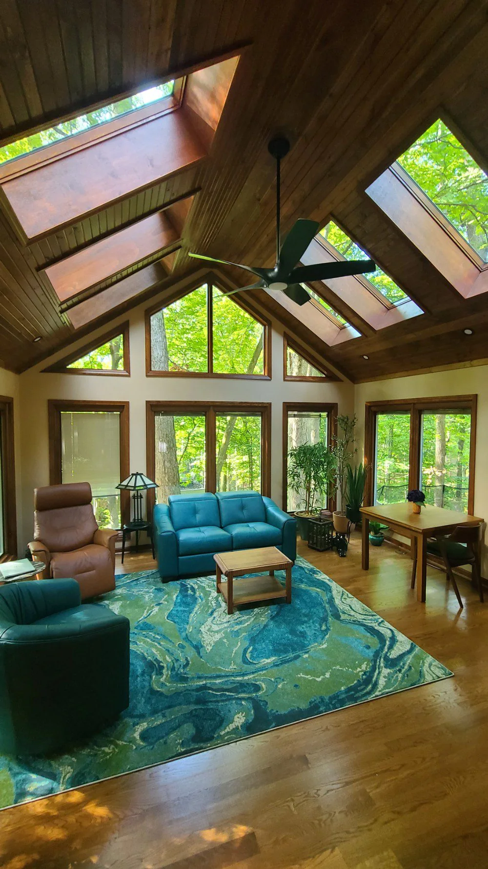 Wood-lined sunroom with broad windows